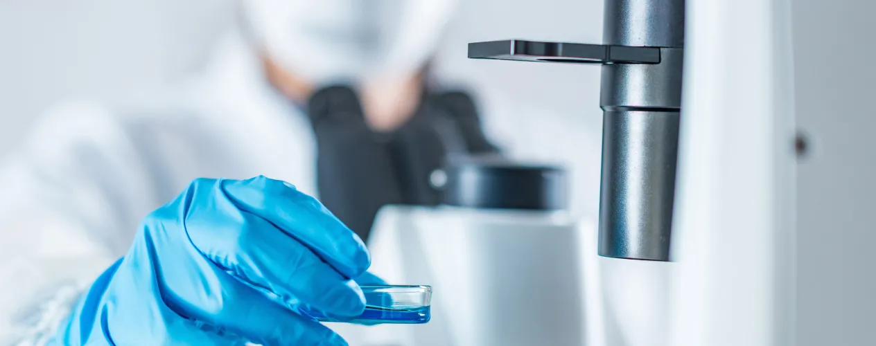 researcher in lab examining specimen