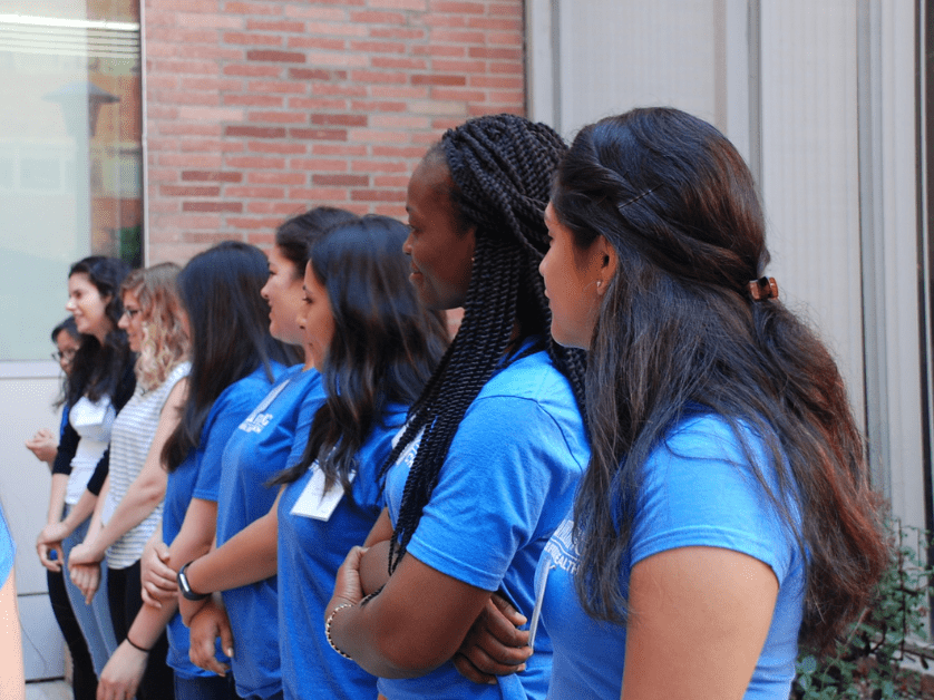 students standing in front of school buillding
