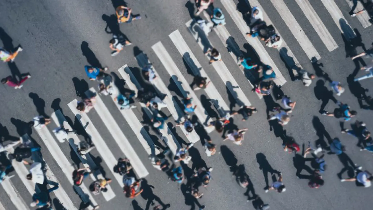 People walking through a busy crosswalk